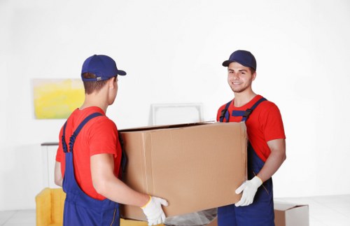 Moving boxes and household items with a removal truck in Merton Park