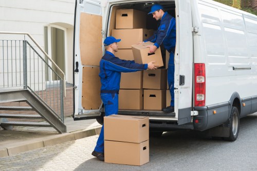 Boxes, wrapped furniture, and moving equipment ready for loading