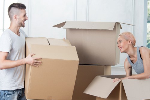 Removal team transporting boxes and furniture securely