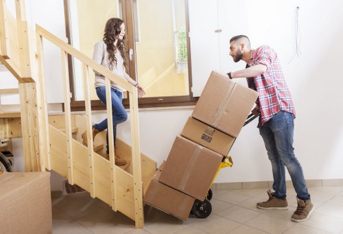 Loading household items into a removals van on a residential street